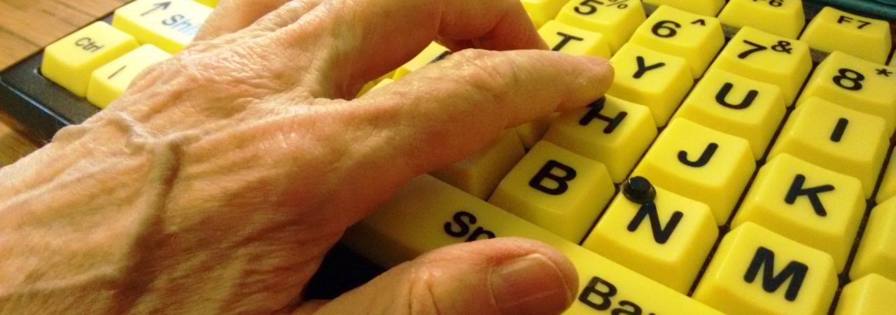 Hand-on-high-contrast-accessible-computer-keyboard